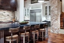 04 a rustic kitchen with a rich-colored wood floor and whitewashed vintage wooden chairs