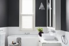 a modern bathroom design with black walls and white appliances