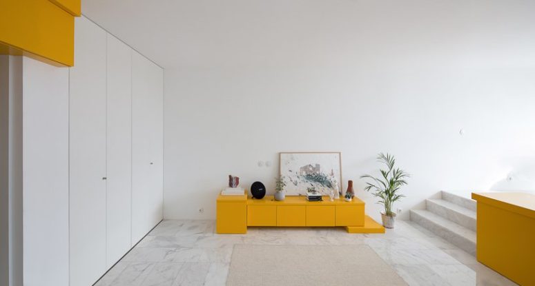 bight and cool storage solution for a living room A small storage cabinet in bold yellow in the living room zone is also great for storage