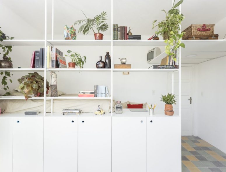 The shelves are airy and ethereal, yet they separate the sleeping and living zone