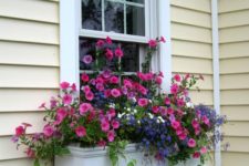 05 a small white window box with bright pink and purple blooms and cascading greenery will add a colorful touch