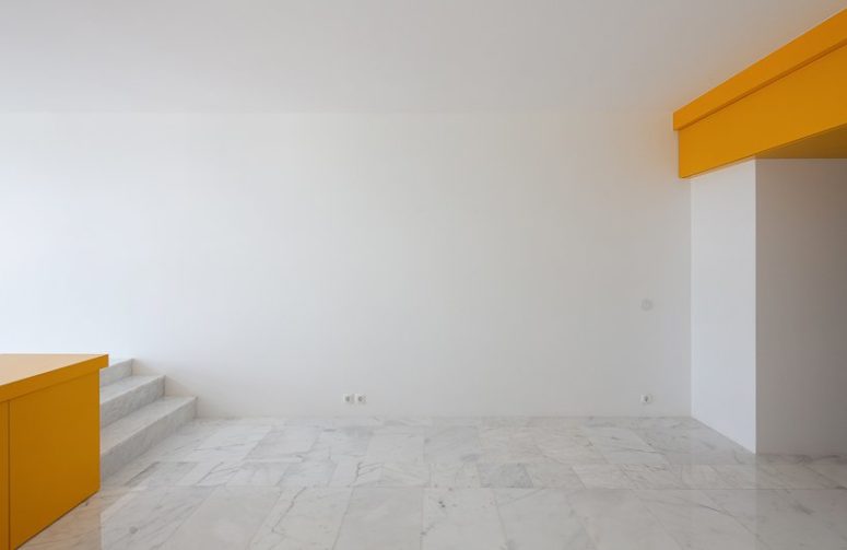 marble flooring is a luxurious touch The floor is clad with marble-inspired tiles in grey and white