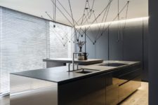 a contemporary dark kitchen design with a large island