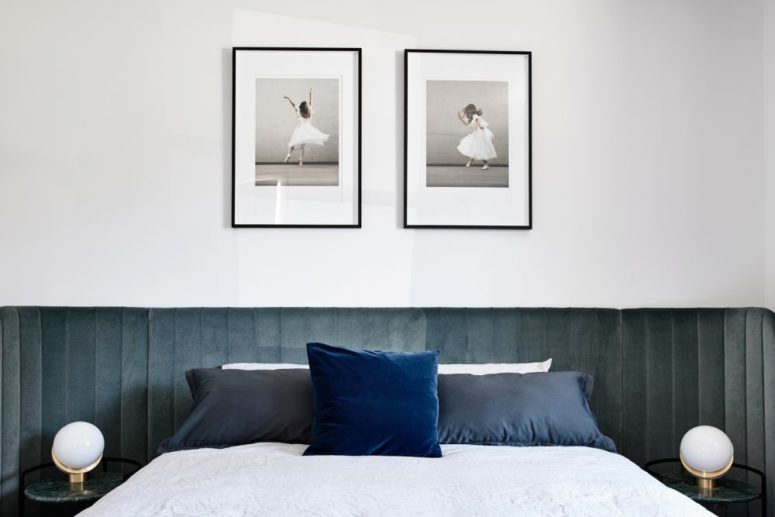 a contemporary bedroom design with wood walls The master bedroom is done with a wood clad wall, a large bed and some artworks and ball lamps