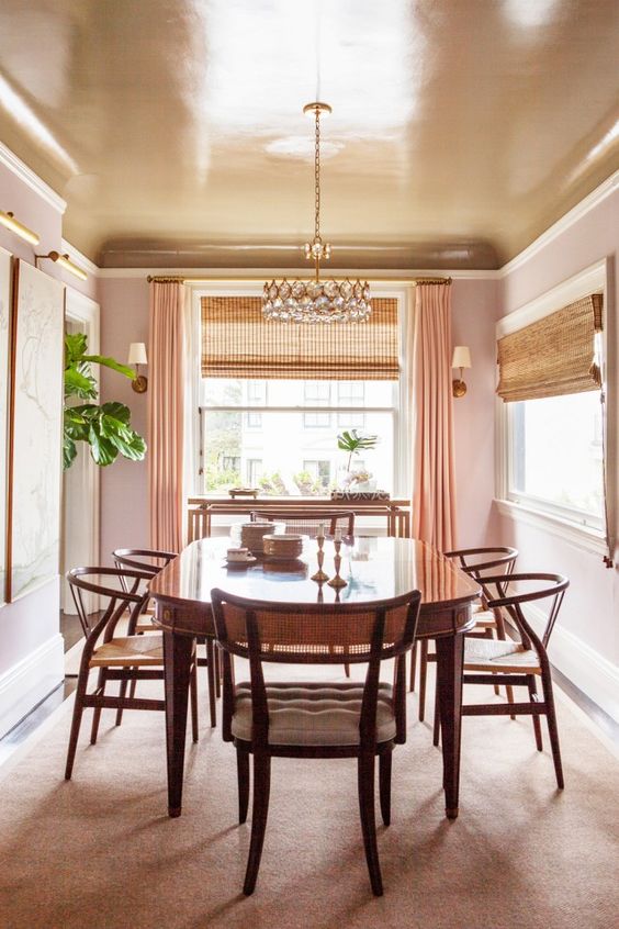 a copper dining room ceiling keeps the space warm-colored and peachy while adding a shiny touch to it