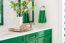 09 a bright emerald vanity accented with brass handles and matching frames and towels over the vanity