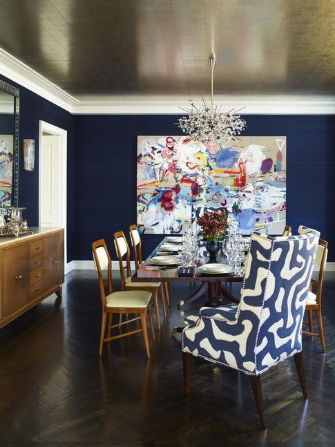 a high drama dining room done in navy and creamy with a gorgeous gold ceiling that adds a glam feel