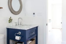14 a bright blue small vanity with a stone countertop and some storage space is a bright statement
