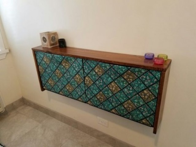 a retro-inspired IKEA Trones shoe cabinet with a rich-colored wooden tabletop and colorful contact paper doors