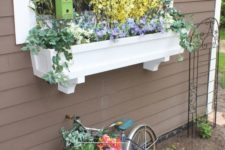 a cute bird house is a chic addition to window box planter