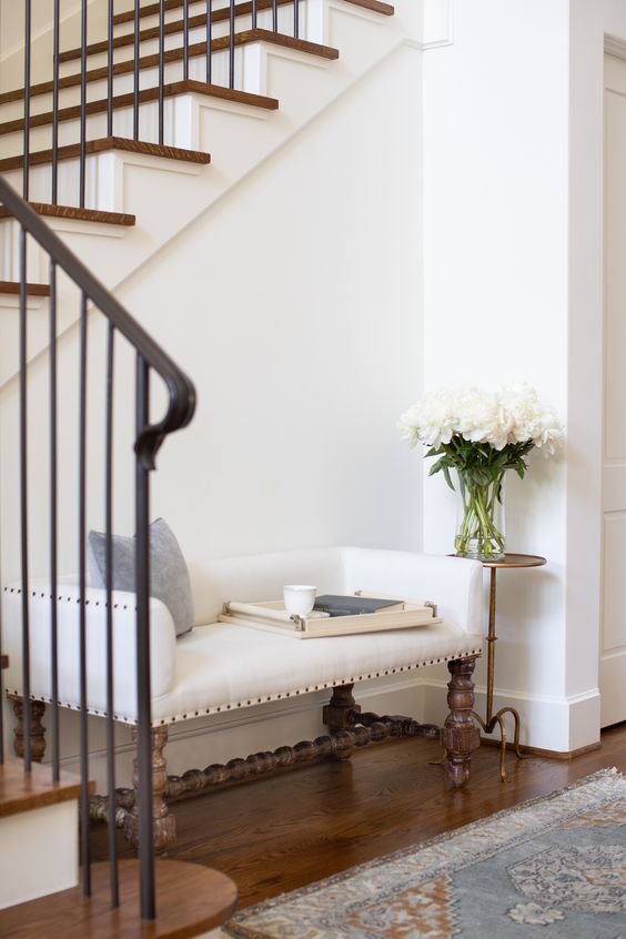 a refined vintage bench with a beautiful wooden base and a chic upholstered seat