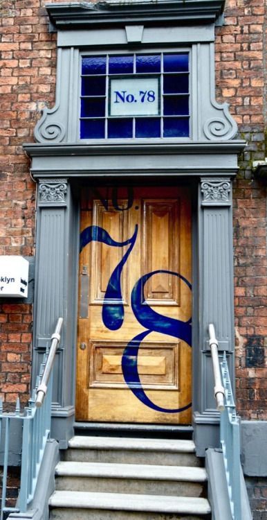 bright house numbers painted right on the front door is a stylish and fun idea for a modern space