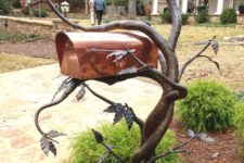 17 a curved metal tree with leaves and a copper box is a gorgeous and mysterious idea
