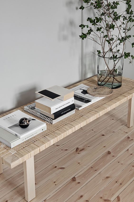 a woven wooden bench brings an outdoor feel indoors making the space more relaxed