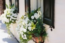 18 little wooden window box planters with lush white blooms, foliage and cascading greenery look chic