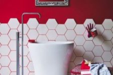 19 a hot red statement wall and hot red grout that accents the hex tiles on the wall and floors