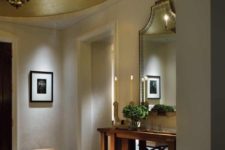 20 a contemporary and refined entryway spruced up with a round gold ceiling medallion and a chic chandelier