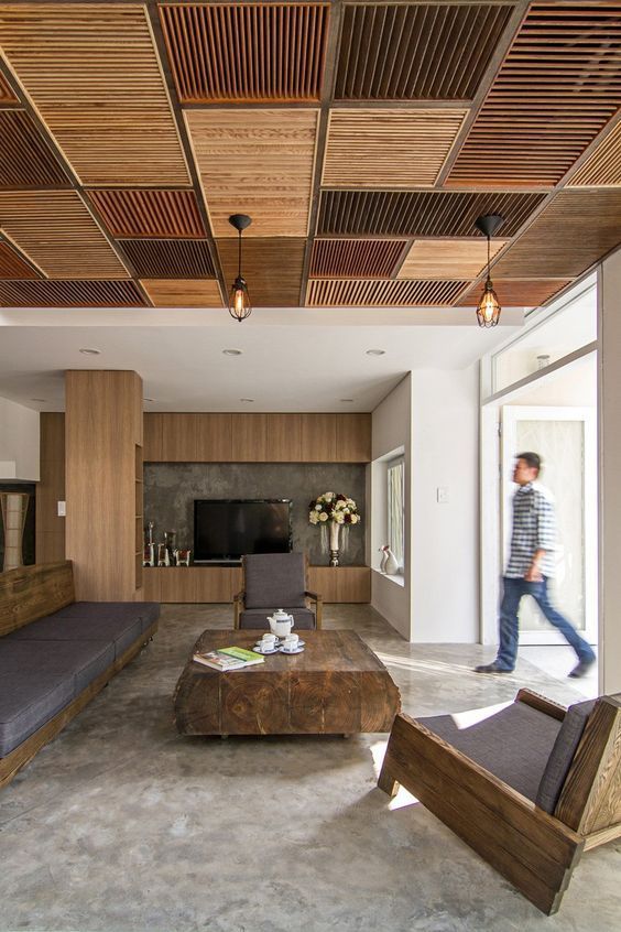 a patchwork ceiling made of wooden shutters done in earthy and muted tones brigns that wow factor to the room