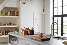 20 an oversized concrete kitchen islnd with open storage is a bold modern idea