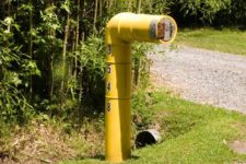 21 a submarine-inspired mailbox in industrial style, in a bold yellow shade and with house numbers written on it