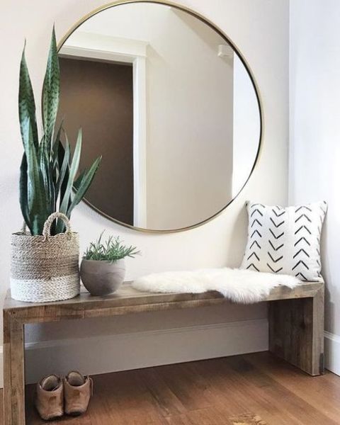 an oversized round mirror is a gorgeous edgy statement for an entryway, it fills the space with light and is a practical idea