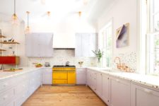 22 a lilac kitchen accented with a bright yellow cooker and a polka dot backsplash plus brass lamps