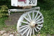 22 a vintage wheel and a wooden plank to hold a vintage mailbox with house numbers on it – cool for a refined touch