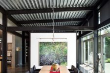 24 a contemporary dining room with a corrugated steel ceiling that makes the space less formal