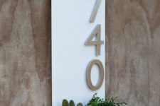 24 a white wall planter with aluminum numbers and cacti and succulents in the planter for a modern feel