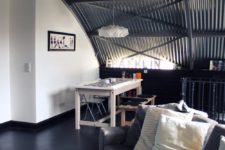 27 a masculine space with a corrugated steel arched ceiling that adds to the style of the space