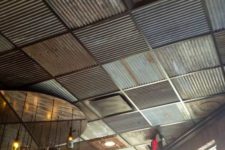 30 a unique industrial ceiling done with mismatching steel sheets in various colors and an industrial chandelier
