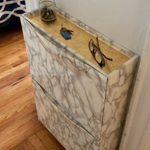 spruce up your IKEA Trones piece with marble and wood grain contact paper to give it a cool and chic look