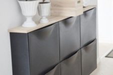 31 a chic IKEA Trones storage cabinet painted black and given a new top is a stylish piece for a Scandinavian space
