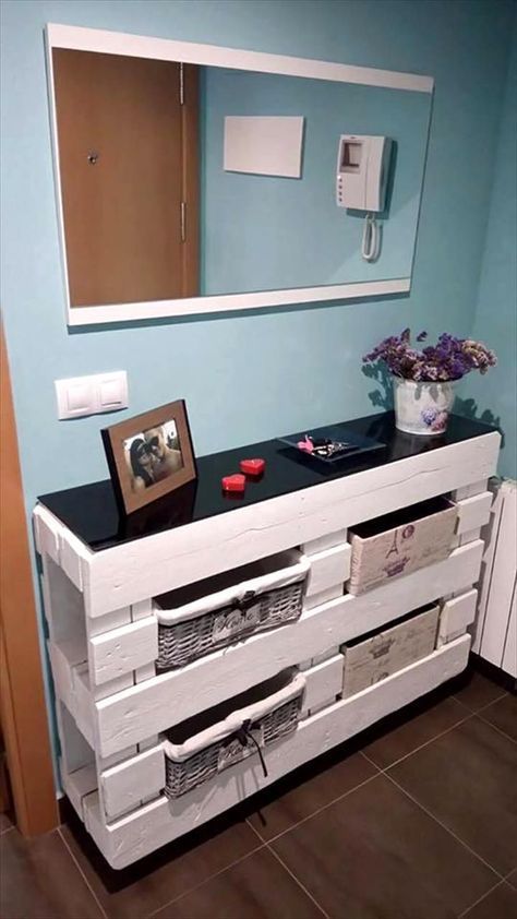 a sleek entryway console built of two pallets for storage and with a black tabletop is an easy craft