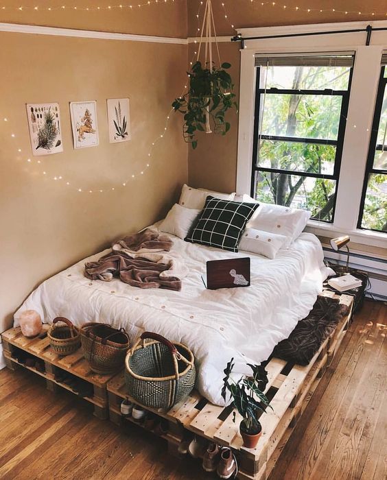 a cozy pallet bed with storage space inside and on top - some baksets and lamps can be accommodated here