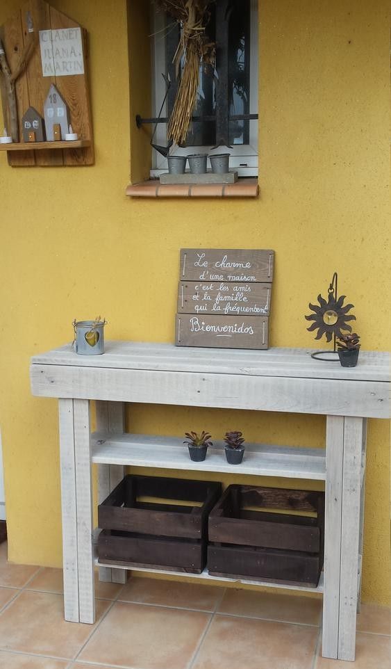 a simple sleek console table of pallet wood painted grey features two shelves for storage