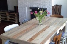 08 a neutral dining table of stained pallet wood and mismatching chairs for an eclectic dining space