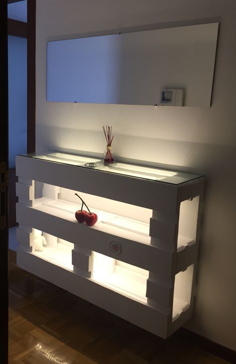 a pallet console table painted white, with much storage space, a glass tabletop and additional inner lights