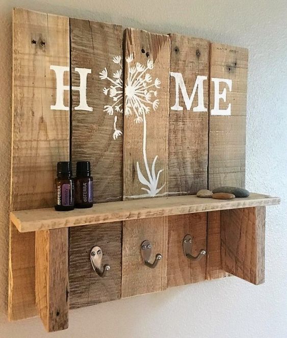 a rustic pallet shelf with some space for storage, hooks and decor acts as a storage piece and an artwork
