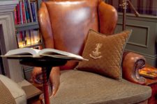 09 a large vintage leather and fabric chair is very refined, a metal floor lamp and a book stand for more comfort