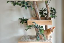 09 a nature-inspired cat tree of branches, fake greenery and platforms with pebbles to make the cats feel like outdoors