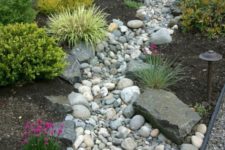 12 a beautiful and low maintenance garden incorporating a river rock dry stream with herbs and blooms around