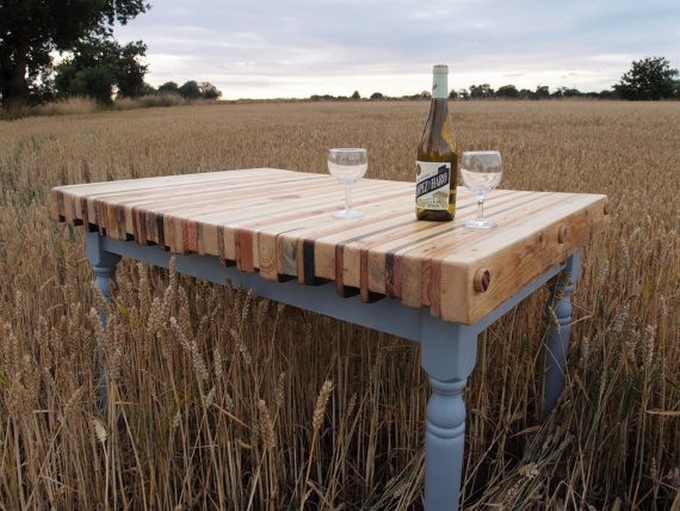 a gorgeous vintage-inspired dining table made of refined grey legs and a frame and a colorful stained pallet tabletop