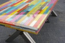 15 a colorful pallet dining table with a resin tabletop and comfy trestle legs is a unique idea