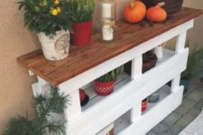 15 a cozy rustic console table made of two pallets in white and a stained wooden tabletop looks cool