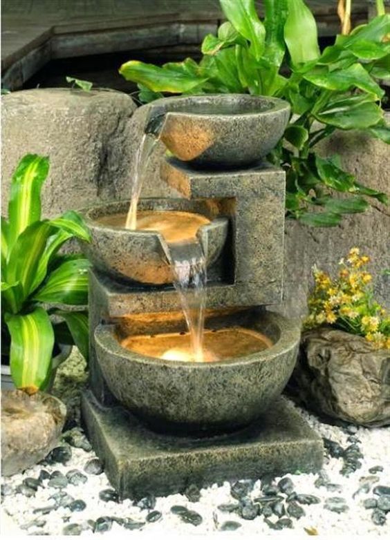 a cool lit up bowl water feature like this one looks modern enough and adds light and sound to your front yard