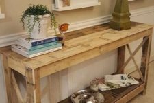 17 a large rustic console of pallet wood with a shelf and planks on the sides is ideal for a vintage space