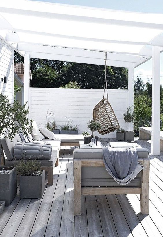 https://www.digsdigs.com/photos/2019/03/17-a-welcoming-summer-lounge-with-comfortable-wooden-furniture-and-touches-of-concrete-plus-a-rattan-chair.jpg