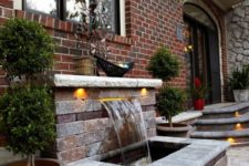 20 a water feature clad with brick and some additional lights is an elegant and stylish idea for a front yard