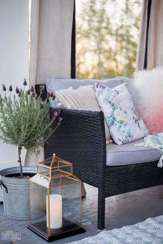 a candle lantern and potted blooms make this space more welcoming and hygge-like
